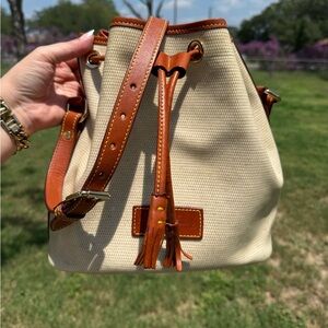 Vintage Dooney and Bourke cream, coated canvas leather drawstring bucket bag